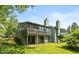 Back exterior view of home with a screened-in porch, sliding glass doors, and well-manicured lawn at 4965 Hawthorne Way, Avon, IN 46123