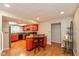 Bright kitchen with red cabinets and island with butcher block countertop, hardwood floors, and stainless steel appliances at 4965 Hawthorne Way, Avon, IN 46123