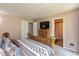 Comfortable main bedroom featuring wood bed frame, carpet flooring, neutral walls, walk-in closet, and en suite bathroom at 4965 Hawthorne Way, Avon, IN 46123
