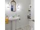 Charming half-bathroom features a pedestal sink, stylish fixtures, and decorative elements, offering a fresh and inviting space at 5108 Riverview Dr, Indianapolis, IN 46208
