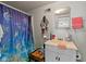 Cozy bathroom with a single vanity and a shower with a themed curtain at 5108 Riverview Dr, Indianapolis, IN 46208