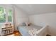 Bright bedroom showcases hardwood floors, a white bed frame, and a large window, creating a cozy and inviting space at 5108 Riverview Dr, Indianapolis, IN 46208
