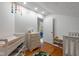 Well-lit Bedroom featuring a changing table, hardwood floors, and a view into another room, creating a nurturing atmosphere at 5108 Riverview Dr, Indianapolis, IN 46208