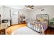 Bright bedroom with a unique metal bed frame, hardwood floors, and ample natural light, creating a serene atmosphere at 5108 Riverview Dr, Indianapolis, IN 46208