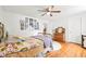 Comfortable bedroom showcasing hardwood floors, a cozy bed, and charming decor, offering a relaxing retreat at 5108 Riverview Dr, Indianapolis, IN 46208