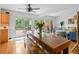 Bright dining area with hardwood floors and access to the outdoor deck at 5108 Riverview Dr, Indianapolis, IN 46208