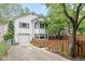 Charming two-story home with attached garage, bay window and lush landscaping at 5108 Riverview Dr, Indianapolis, IN 46208