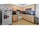 Functional kitchen with wood cabinets, white appliances, and colorful backsplash at 5108 Riverview Dr, Indianapolis, IN 46208