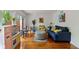 Cozy living room boasts hardwood floors, a comfortable blue sofa, and artistic decor, offering a welcoming space at 5108 Riverview Dr, Indianapolis, IN 46208