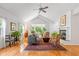 Bright living room with vaulted ceilings, fireplace, and hardwood floors at 5108 Riverview Dr, Indianapolis, IN 46208