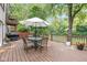 Spacious outdoor deck with an umbrella-shaded dining set, perfect for entertaining and enjoying the serene surroundings at 5108 Riverview Dr, Indianapolis, IN 46208