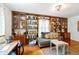 Cozy sitting room featuring custom built-in bookshelves and a comfortable seating area at 5108 Riverview Dr, Indianapolis, IN 46208