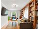 Comfortable den featuring custom built-in bookshelves, hardwood floors and natural light at 5108 Riverview Dr, Indianapolis, IN 46208