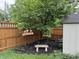 Backyard features a flower bed, shade tree, privacy fence, shed and a stone bench at 537 N 17Th St, Noblesville, IN 46060
