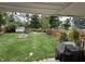 Wide angle of a expansive backyard with fire pit, shed, garden box, green grass and a fence at 537 N 17Th St, Noblesville, IN 46060