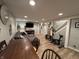 Finished basement area with a sectional couch, table, workout bike and bright recessed lighting at 537 N 17Th St, Noblesville, IN 46060