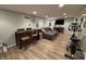 Open basement area features a sectional couch, table with chairs, and workout bike, great for entertaining at 537 N 17Th St, Noblesville, IN 46060