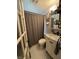 Bathroom with hexagon tile floor, gray shower curtain, and white vanity at 537 N 17Th St, Noblesville, IN 46060