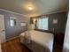 Relaxing bedroom with hardwood floors, a neutral color scheme, and a large window at 537 N 17Th St, Noblesville, IN 46060