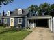 Charming home featuring a yellow front door, dormer windows, well-manicured lawn and attached carport at 537 N 17Th St, Noblesville, IN 46060