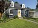 Charming home with blue siding, dormer windows, a yellow front door, and manicured landscaping at 537 N 17Th St, Noblesville, IN 46060