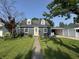 Beautiful home with blue exterior and a yellow door and a lovely green front lawn at 537 N 17Th St, Noblesville, IN 46060