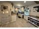 Bright kitchen features white cabinets, stainless appliances, hanging plants, and access to the rest of the home at 537 N 17Th St, Noblesville, IN 46060