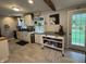 Bright kitchen with white cabinets, stainless steel appliances, rolling island, and a view of the spacious backyard at 537 N 17Th St, Noblesville, IN 46060