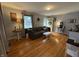 Comfortable living room featuring hardwood floors, grey couch, and large windows for plenty of natural light at 537 N 17Th St, Noblesville, IN 46060