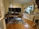 Office space with hardwood floors, two monitors, a neutral palette, and bright window with hanging plants at 537 N 17Th St, Noblesville, IN 46060