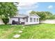This fenced backyard offers a comfortable seating area, grill, and lush green space at 5651 Pine Knoll Blvd, Noblesville, IN 46062