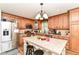 Spacious kitchen with wooden cabinetry, stainless steel appliances, and a functional center island at 5651 Pine Knoll Blvd, Noblesville, IN 46062