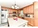 Bright kitchen featuring wooden cabinets, stainless steel appliances, and a convenient center island at 5651 Pine Knoll Blvd, Noblesville, IN 46062