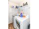 This laundry room boasts modern appliances and open shelving for ample storage and organization at 5651 Pine Knoll Blvd, Noblesville, IN 46062