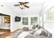 Inviting living room with bright light, comfortable sectional, and a view of kitchen at 5651 Pine Knoll Blvd, Noblesville, IN 46062