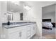Elegant bathroom with a double vanity and granite countertops, adjoining the bedroom at 5655 Lighthouse Dr, Brownsburg, IN 46112