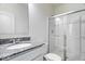 Modern bathroom featuring a granite countertop, shower with glass doors, and updated fixtures at 5655 Lighthouse Dr, Brownsburg, IN 46112