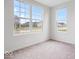 Sunlit bedroom with neutral carpet and large windows offering views of the surrounding neighborhood at 5655 Lighthouse Dr, Brownsburg, IN 46112