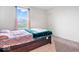 A cozy bedroom featuring a bed with patterned bedding and a large window, offering natural light at 5655 Lighthouse Dr, Brownsburg, IN 46112