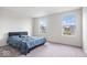 Bright bedroom with plush carpet, two large windows, and a comfortable-looking queen-size bed at 5655 Lighthouse Dr, Brownsburg, IN 46112
