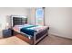 Inviting bedroom featuring a queen bed with padded headboard, nightstand with lamp, and carpet flooring at 5655 Lighthouse Dr, Brownsburg, IN 46112