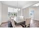 Neutral dining room showcasing a large table with seating for eight, with a window view and modern lighting at 5655 Lighthouse Dr, Brownsburg, IN 46112