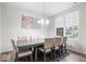 Elegant dining room features neutral chairs, a decorative chandelier, and a window providing natural light at 5655 Lighthouse Dr, Brownsburg, IN 46112