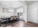 Bright dining room with a chandelier and a large table set for eight, offering a view through a window at 5655 Lighthouse Dr, Brownsburg, IN 46112
