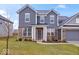 Charming two-story home with brick and siding, a manicured lawn, and a two-car garage at 5655 Lighthouse Dr, Brownsburg, IN 46112