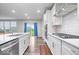 Modern kitchen featuring white cabinets, stainless steel appliances, and a center island facing sliding glass doors at 5655 Lighthouse Dr, Brownsburg, IN 46112