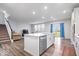 Bright kitchen with white cabinets, stainless steel appliances, and a large island offering a view of the backyard at 5655 Lighthouse Dr, Brownsburg, IN 46112