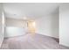 Open loft area with neutral carpet and white walls, perfect as a flexible space for relaxation or entertainment at 5655 Lighthouse Dr, Brownsburg, IN 46112