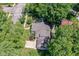 Aerial view of a single-Gathering home surrounded by lush greenery and mature trees at 5681 Carrollton Ave, Indianapolis, IN 46220