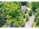 Aerial view of a single-Gathering home surrounded by lush greenery and mature trees at 5681 Carrollton Ave, Indianapolis, IN 46220